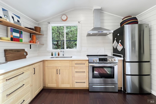 kitchen with wall chimney exhaust hood, a sink, lofted ceiling, stainless steel appliances, and light brown cabinets
