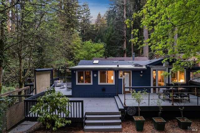 rear view of house featuring a deck