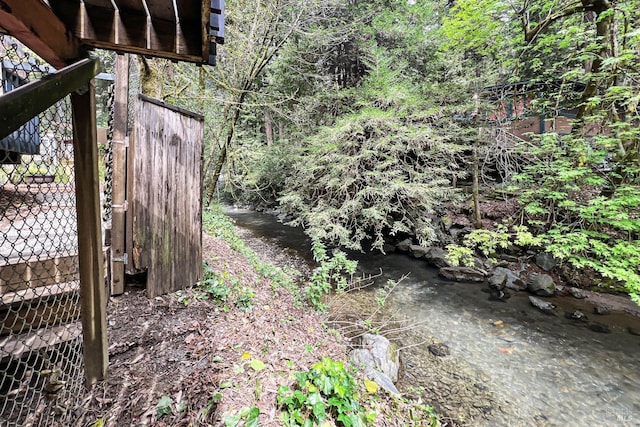 view of yard featuring a forest view