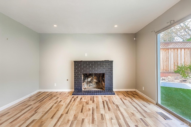 unfurnished living room featuring visible vents, baseboards, recessed lighting, and wood finished floors