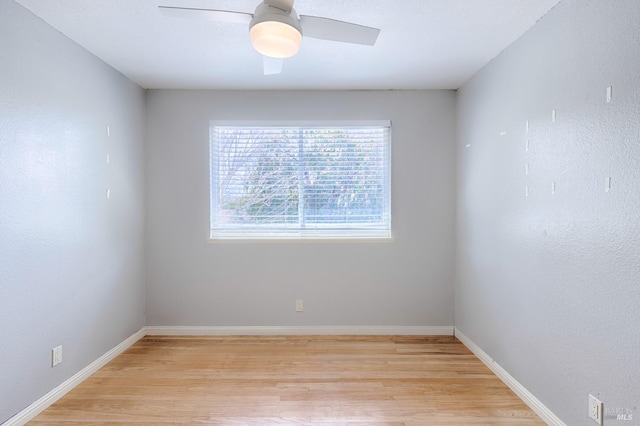 unfurnished room with baseboards, light wood-type flooring, and ceiling fan