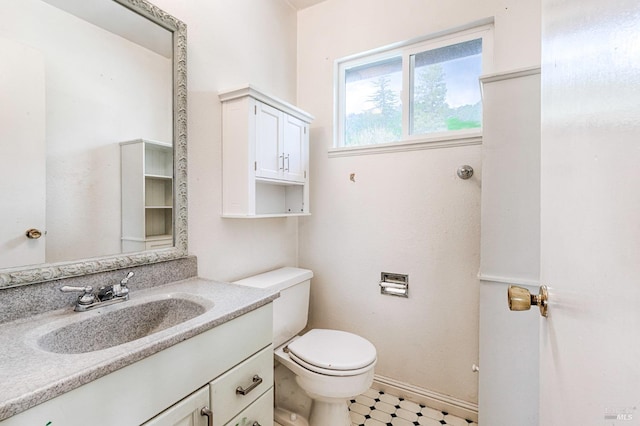 bathroom featuring toilet, tile patterned floors, and vanity