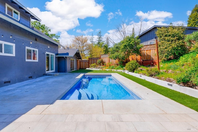view of swimming pool with a fenced in pool, a patio, and a fenced backyard