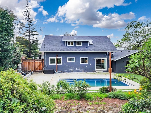 back of house featuring a fenced in pool, a patio, stucco siding, fence, and a shingled roof