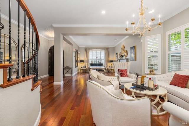 living area featuring a chandelier, arched walkways, stairway, and wood finished floors