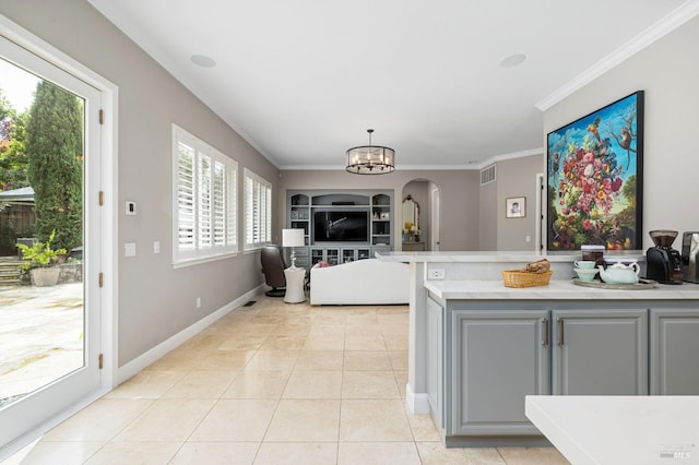 kitchen featuring light tile patterned floors, arched walkways, visible vents, light countertops, and gray cabinetry