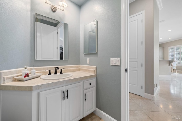 bathroom featuring tile patterned floors, vanity, and baseboards