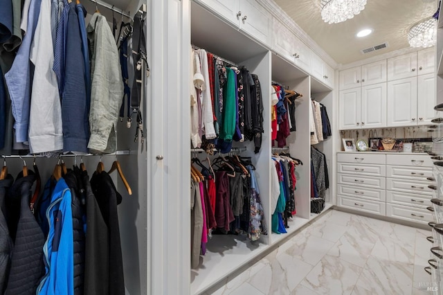 spacious closet featuring visible vents and marble finish floor
