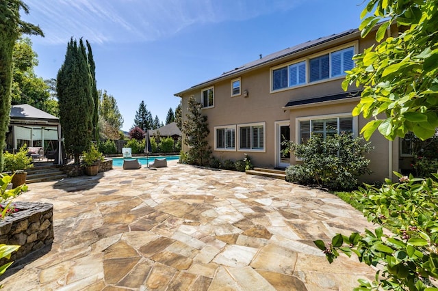view of patio / terrace featuring a fenced in pool, a gazebo, and fence