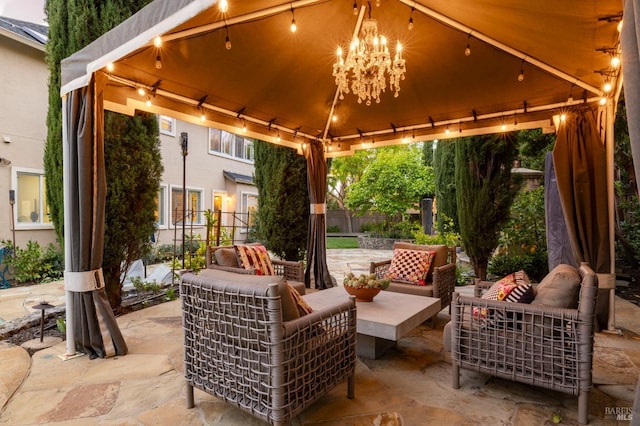 view of patio with a gazebo, an outdoor living space, and fence