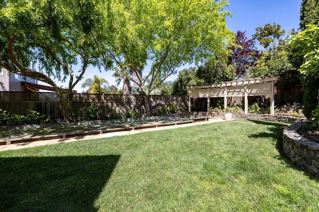 view of yard with fence and a pergola