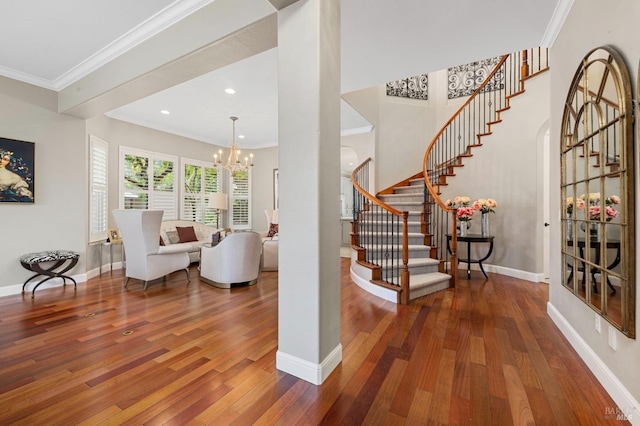 interior space featuring crown molding, recessed lighting, a chandelier, wood-type flooring, and baseboards