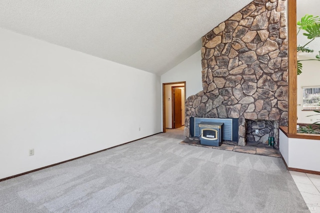 unfurnished living room featuring a wood stove, baseboards, high vaulted ceiling, a textured ceiling, and carpet