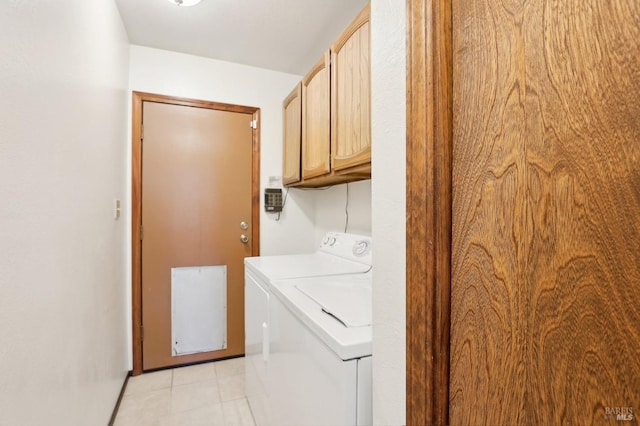 laundry area featuring cabinet space, washing machine and dryer, and light tile patterned flooring