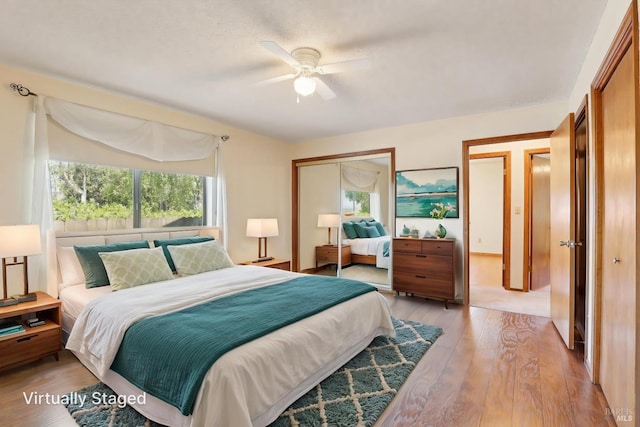 bedroom with a ceiling fan, a closet, and wood finished floors