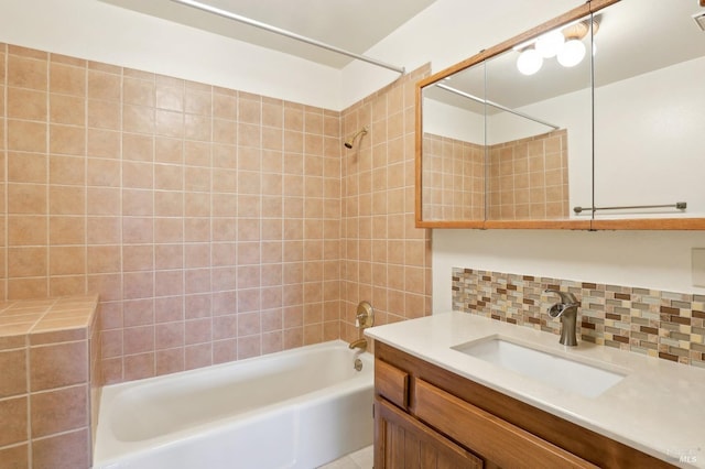 bathroom with vanity, backsplash, and shower / bathtub combination