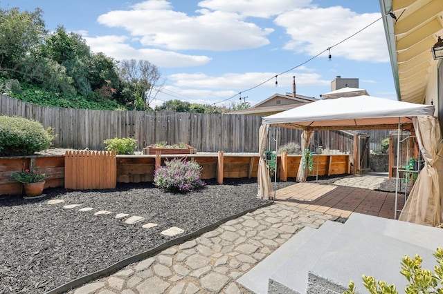 view of patio with a gazebo and a fenced backyard