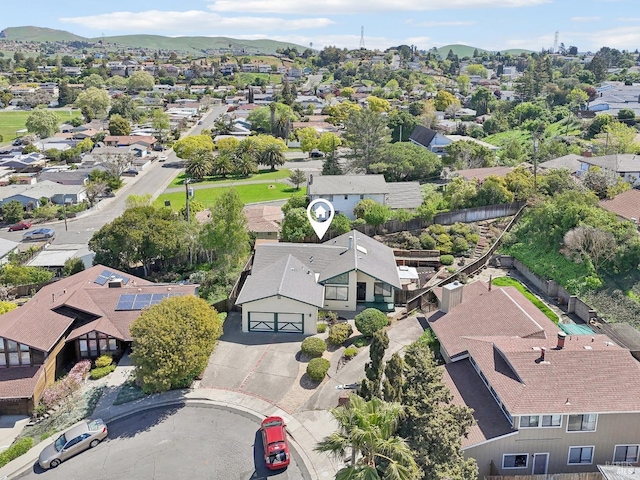 drone / aerial view featuring a residential view and a mountain view