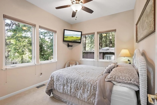 bedroom with ceiling fan, visible vents, baseboards, and carpet