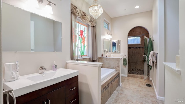 bathroom featuring vanity, a chandelier, a shower stall, visible vents, and a garden tub