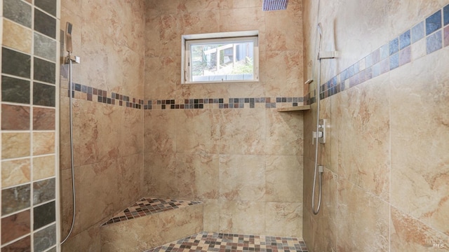 bathroom featuring a tile shower
