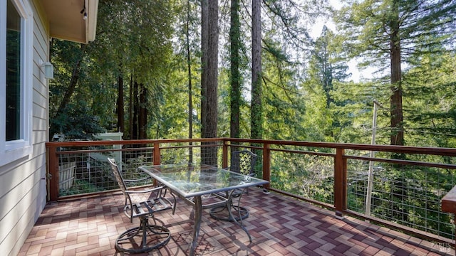 wooden deck with a patio and outdoor dining area