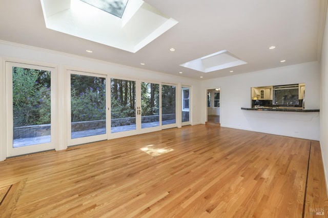 1065 Meadowsweet Dr, Corte Madera, CA 94925 - unfurnished living room with recessed lighting, light wood-type flooring, ornamental molding, and a skylight