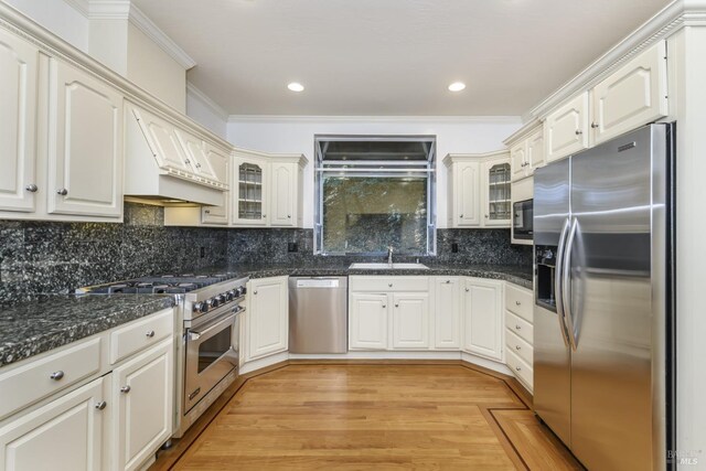 1065 Meadowsweet Dr, Corte Madera, CA 94925 - kitchen with glass insert cabinets, a sink, ornamental molding, light wood-type flooring, and appliances with stainless steel finishes
