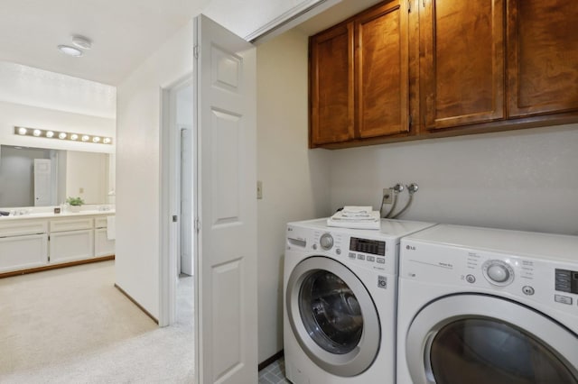 washroom with separate washer and dryer, light colored carpet, and cabinet space