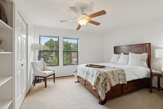 carpeted bedroom featuring baseboards and ceiling fan