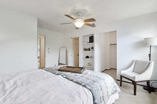 bedroom with a ceiling fan and light colored carpet