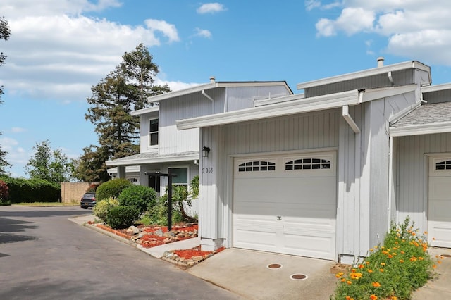 view of front of house with concrete driveway and a garage