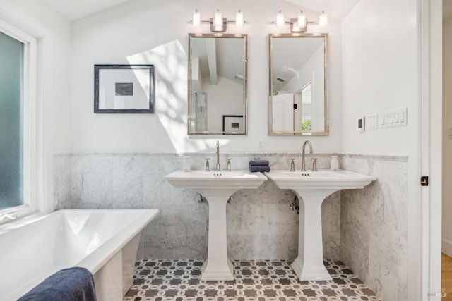 1423 Butterfield Rd, San Anselmo, CA 94960 - bathroom featuring tile walls, a freestanding tub, a wainscoted wall, and a sink