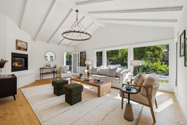 1423 Butterfield Rd, San Anselmo, CA 94960 - living area featuring light wood-type flooring, a glass covered fireplace, beamed ceiling, high vaulted ceiling, and a chandelier