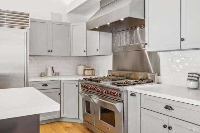 1423 Butterfield Rd, San Anselmo, CA 94960 - kitchen with high end appliances, wall chimney exhaust hood, light countertops, and backsplash