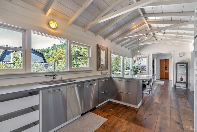 kitchen with a sink, dark wood-style floors, stainless steel dishwasher, a peninsula, and a kitchen bar