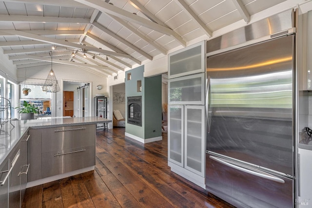 kitchen featuring high end fridge, dark wood finished floors, modern cabinets, oven, and glass insert cabinets