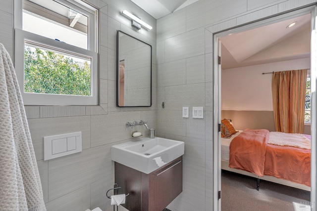 ensuite bathroom with tile walls and vanity