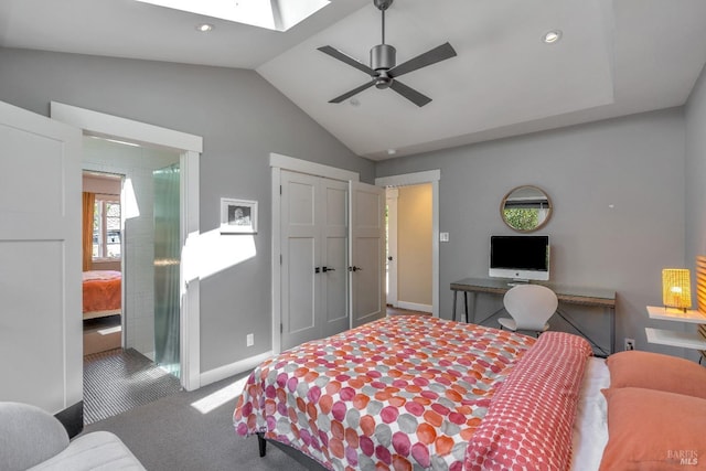 carpeted bedroom featuring vaulted ceiling, a skylight, baseboards, recessed lighting, and a closet