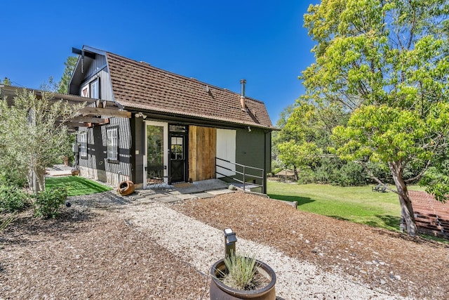 rear view of property with a lawn