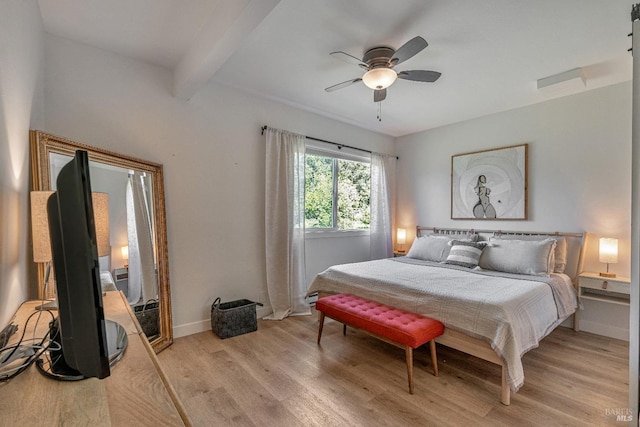 bedroom with light wood finished floors, beamed ceiling, a ceiling fan, and baseboards