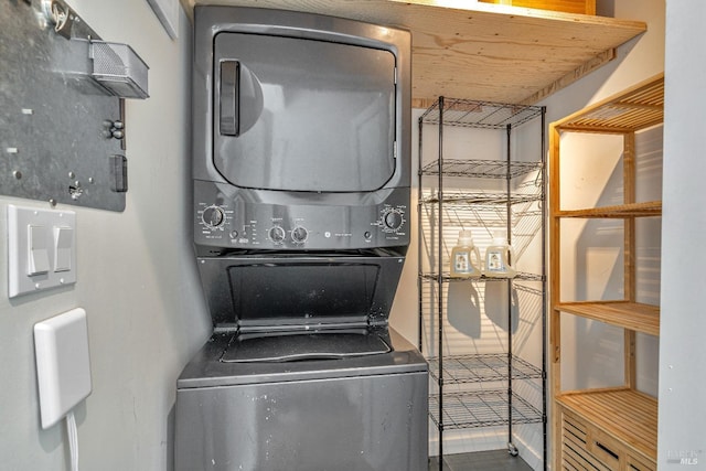 clothes washing area with stacked washing machine and dryer