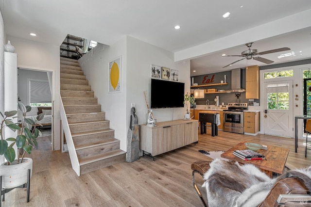 living area with stairs, light wood-style flooring, recessed lighting, and a ceiling fan