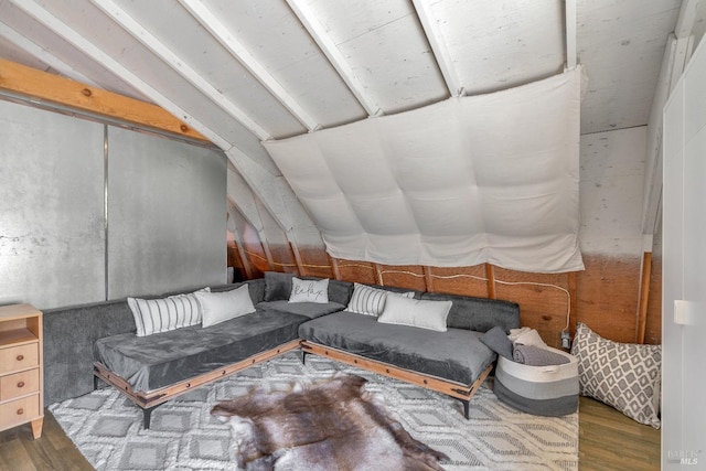living room featuring vaulted ceiling and wood finished floors