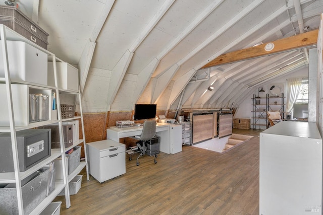 home office with lofted ceiling and wood finished floors