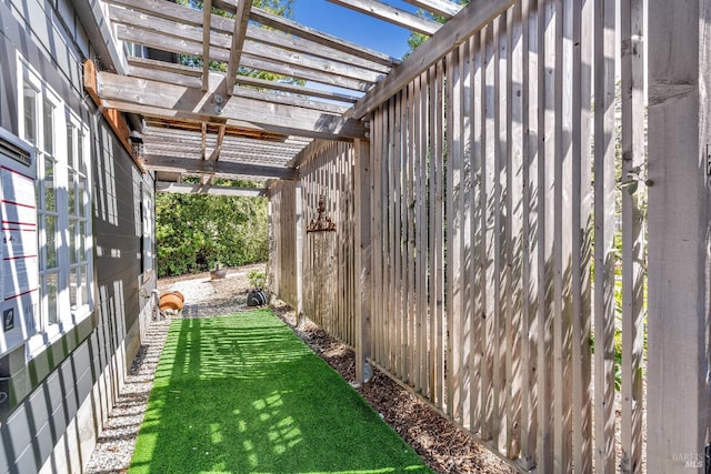 view of green lawn with a pergola
