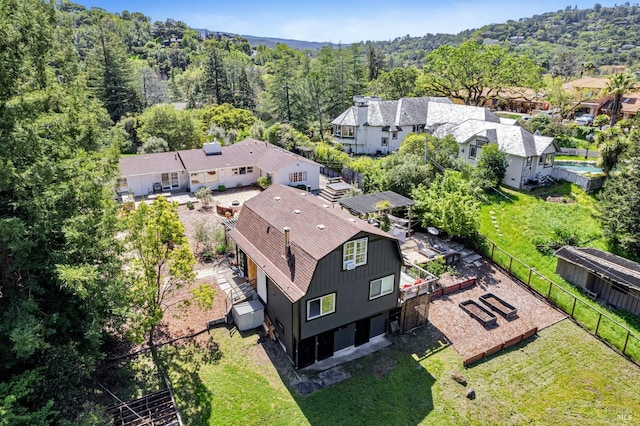 aerial view of residential area featuring a forest