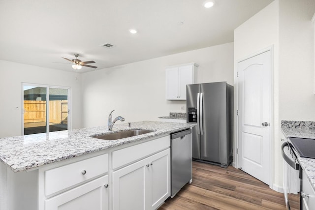 4507 Amble Ln, Riverbank, CA 95367 - kitchen with stainless steel appliances, a sink, an island with sink, ceiling fan, and white cabinetry