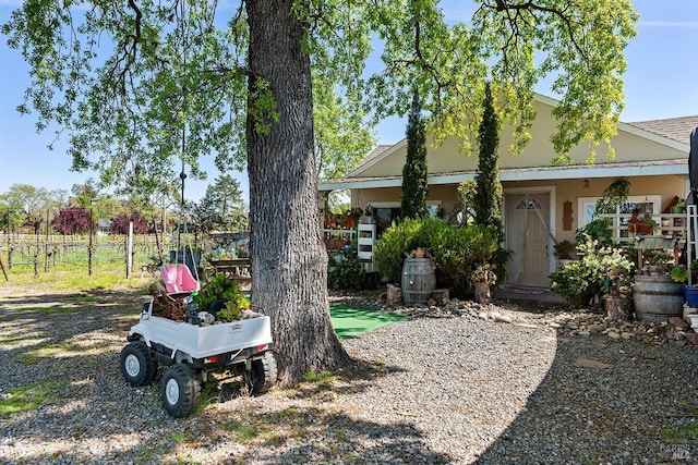 view of front of property featuring fence and stucco siding