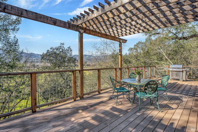 wooden terrace featuring a grill, a pergola, and outdoor dining area